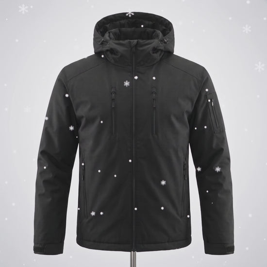 Snow falls on the black Chromapeak jacket and the blue pattern appears